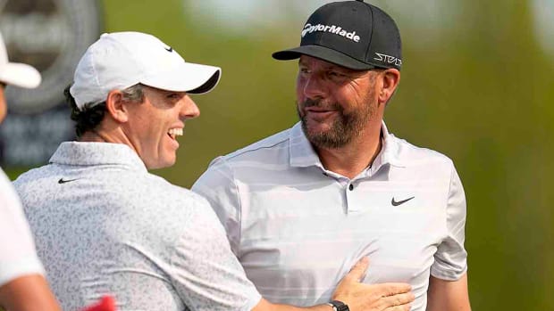Rory McIlroy celebrates with Michael Block after Block's hole in one on the 15th hole during the final round of the 2023 PGA Championship at Oak Hill Country Club.